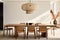 A dining area featuring a minimalist wooden table, modern dining chairs, and a statement pendant light.