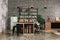 Dining area in industrial style with table, chairs and mint retro fridge. Black vintage brick wall background