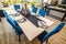 Dining Area With Rectangular Table & Six High Back Blue Chairs