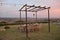 Dining outdoor in the Italian countryside. Decked table al fresco by sunset