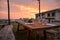 Dining outdoor in Italy. Decked table al fresco by sunset