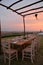 Dining outdoor in Italy. Decked table al fresco by sunset