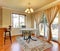 Dining room area with doors and window and simple round table.