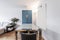 Dining room with glass and metal table, blue oriental style cabinet