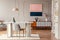 Dining room interior with a table, pink painting and vintage cabinet