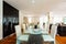 Dining room with leather chairs, glass table and parquet