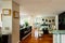 Dining room with leather chairs, glass table and parquet