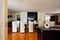 Dining room with leather chairs, glass table and parquet