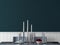 Dining room mockup with dark teal wall, white molding wall, table, and objects