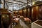 A dining room of an old restaurant with clay vats filled with wine