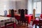 Dining room with red tablecloth and big chairs. Refectory in ancient monastery.