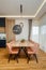 Dining room with a sleek wooden table surrounded by modern pink chairs