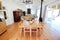 Dining Table With Chairs And Seating Area In Stylish And Contemporary Open Plan Empty Home