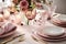 dining table festive setting with delicate flowers and elegant tableware