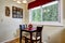 Dining table with flower pot in bright kitchen room