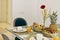 Dining table with glass top and wicker baskets with fresh fruits, sliced bread and sweet rolls with glasses of orange juice