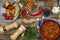 Dining table. Meatballs With parsley and cherry tomatoes and various snacks. Wooden background, top view. Rustic style.