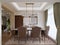 Dining table for six with soft brown chairs and a wooden server table and glass pendant light