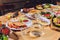 Dining table with a variety of snacks and salads. Salmon, olives, wine, vegetables, grilled fish toast. The concept of a