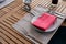 Dining wooden table set with ceramic tableware, silver utensil, red napkin and water