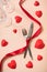 Dinner or lunch preparation for Valentine`s day with various cutlery, red ribbon and hearts