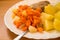 Dinner meal, braised carrot, boiled potatoes and meat