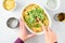 Dinner meal preparation, womanâ€™s hand mixing together ingredients for tuna noodle casserole