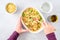 Dinner meal preparation, womanâ€™s hand mixing together ingredients for tuna noodle casserole