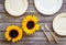 Dinning table decorated with sunflower, dark wooden background top-down
