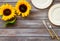 Dinning table decorated with sunflower, dark wooden background top-down copy space