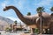 Dinny of Cabazon Dinosaurs displayed next to a Burger King restaurant in California