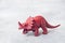 Dinosaur on a gray background. Plastic rubber toy. Selective focus