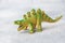 Dinosaur on a gray background. Plastic rubber toy. Selective focus