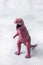 Dinosaur on a gray background. Plastic rubber toy. Selective focus