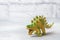 Dinosaur on a gray background. Plastic rubber toy. Selective focus