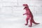 Dinosaur on a gray background. Plastic rubber toy. Selective focus