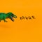 dinosaur with open mouth and inscription rawrr on bright orange background