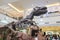 Dinosaur skeleton showing and people watching at department store