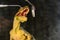 Dinosaur velociraptor examine teeth with dental mirror and probe. The concept of dental care. Toy dinosaur at the reception at the