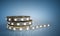 Diode strip Led lights tape in holder close-up 3d render on blue