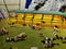 Diorama of cow farm in the countryside where cows are gathering in front of the stable