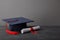 Diploma and academic cap with red