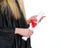 Diploma in hand of woman in graduation gown