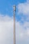 Dipole antenna for telecommunications with blue sky background.
