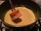 Dipping bread in fondue swiss cheese