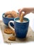 Dipping cookie on mug of milk