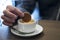 Dipping a Dutch caramel waffle, called Stroopwafel, in coffee