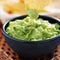 Dipping tortilla chip in guacamole