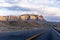 Direct divided highway road in the vast Arizona with mountain and desert plateau