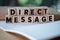 Direct Message word written on wood block